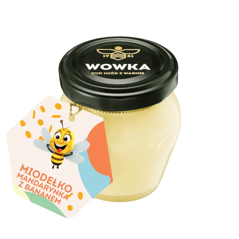 Słoik kremowego miodu Wowka z etykietą Miodełko mandarynka z bananem i uśmiechniętą pszczółką