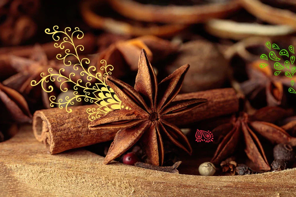 Przyprawy do herbaty: gwiazdki anyżu, cynamon i goździki na drewnianej powierzchni